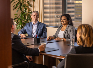People sitting in a conference room around a table